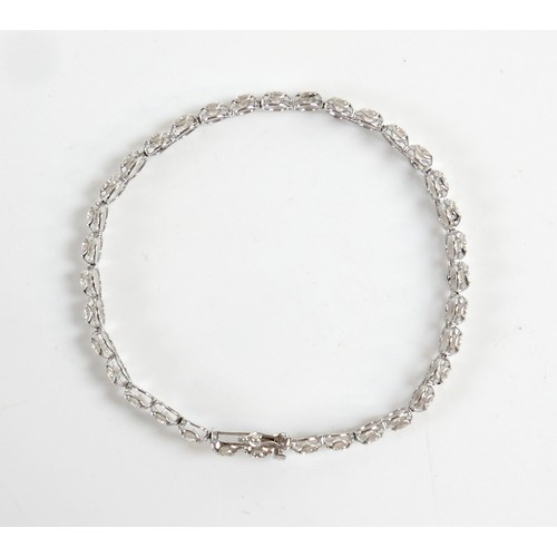 4 - A diamond and platinum tennis bracelet, set with thirty five round cut diamonds, each approx 4.2mm, ... 