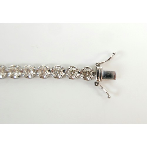 4 - A diamond and platinum tennis bracelet, set with thirty five round cut diamonds, each approx 4.2mm, ... 