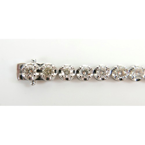 4 - A diamond and platinum tennis bracelet, set with thirty five round cut diamonds, each approx 4.2mm, ... 