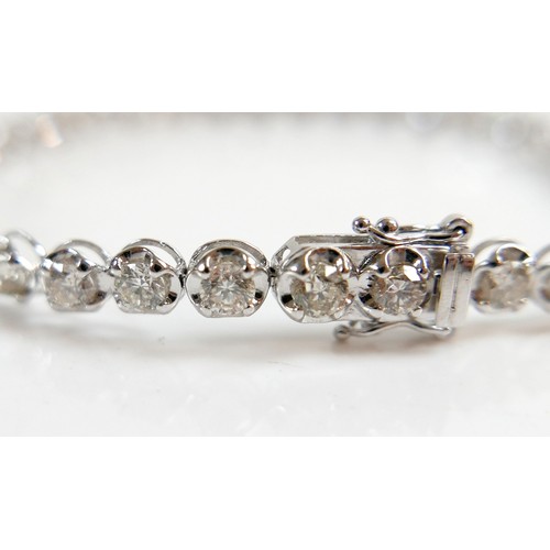 4 - A diamond and platinum tennis bracelet, set with thirty five round cut diamonds, each approx 4.2mm, ... 