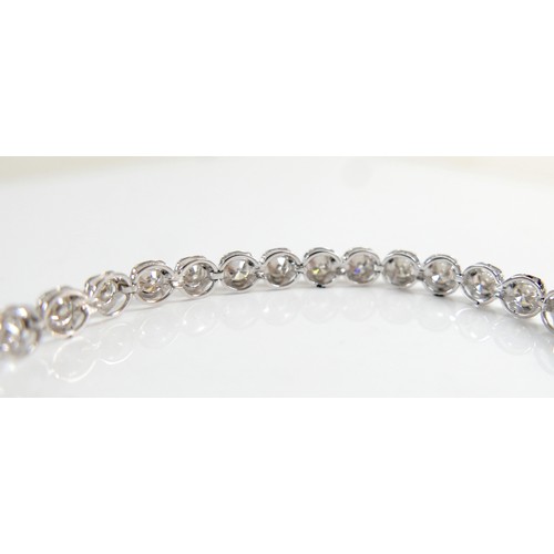 4 - A diamond and platinum tennis bracelet, set with thirty five round cut diamonds, each approx 4.2mm, ... 