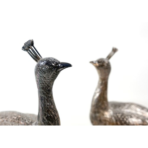218 - A fine and large pair of Art Deco Hanau silver table models of peacocks, each in standing pose with ... 