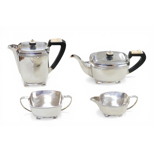 220 - A George VI Art Deco style silver four piece tea set, with two tone mounts to handles and finials of... 