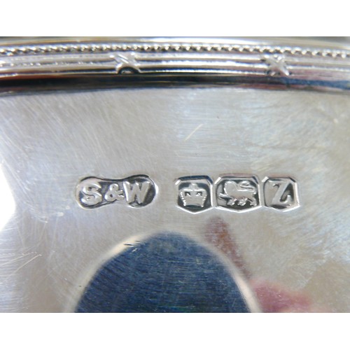 220 - A George VI Art Deco style silver four piece tea set, with two tone mounts to handles and finials of... 