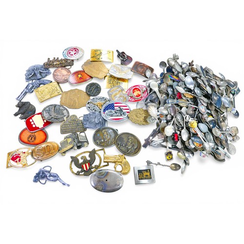 221 - A large collection of souvenir teaspoons and themed belt buckles. (3 bags)