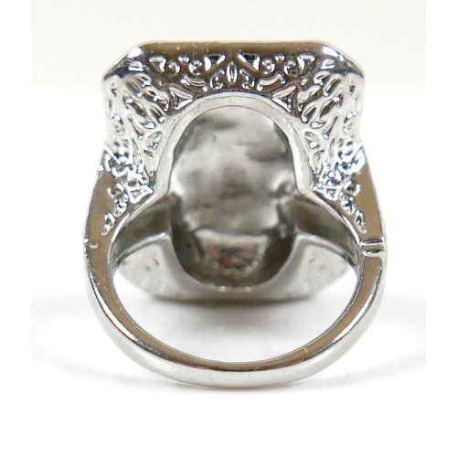38 - An Art Deco style white metal dress ring, head size 24 by 19mm, size M.