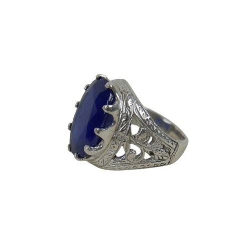 51 - A silver/white metal filled sapphire single stop ring head size 20 by 14mm, ring size O.