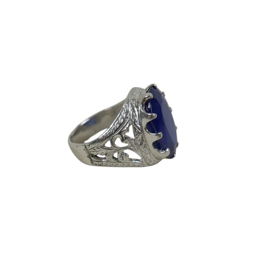51 - A silver/white metal filled sapphire single stop ring head size 20 by 14mm, ring size O.