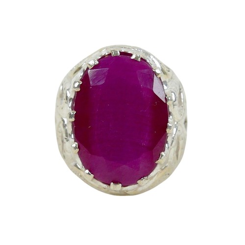 52 - A silver/white metal filled ruby single stone ring head size 23 by 16mm, ring size T.