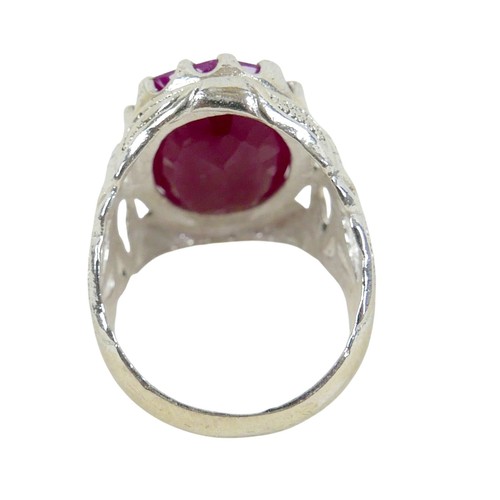 52 - A silver/white metal filled ruby single stone ring head size 23 by 16mm, ring size T.