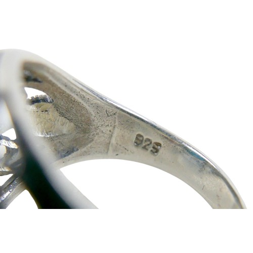 56 - A silver/white metal turquoise ring head size 13 by 16mm, ring size T.