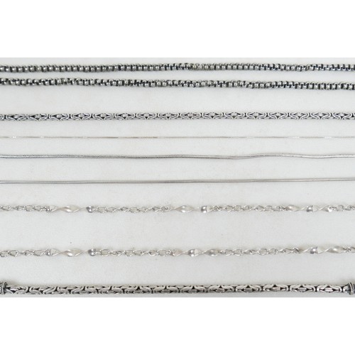 57 - A collection of siver/white metal jewellery and a trinket box comprising six chains, a bracelet, art... 