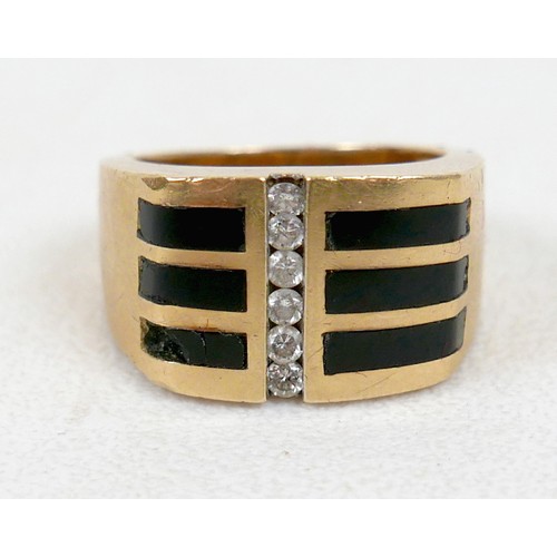 7 - An 18ct yellow gold diamond and black stone ring set with a central row of six small diamonds, ring ... 