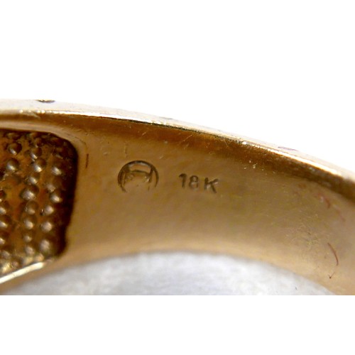 7 - An 18ct yellow gold diamond and black stone ring set with a central row of six small diamonds, ring ... 