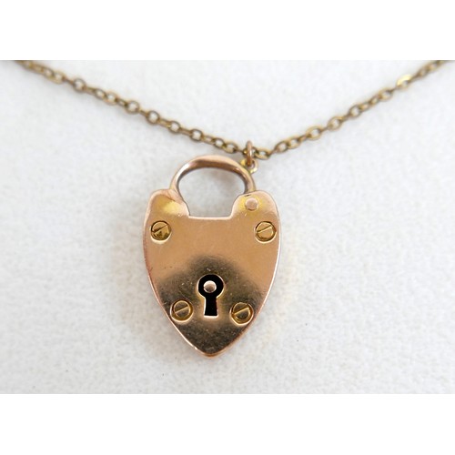 6 - A 9ct gold kerb link charm bracelet, with heart shaped padlock clasp and safety chain, fitted with f... 