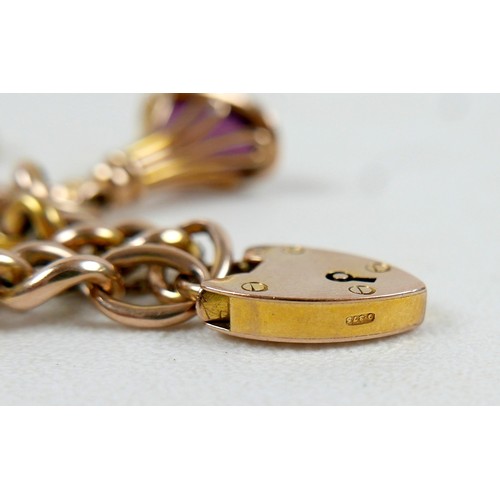 6 - A 9ct gold kerb link charm bracelet, with heart shaped padlock clasp and safety chain, fitted with f... 
