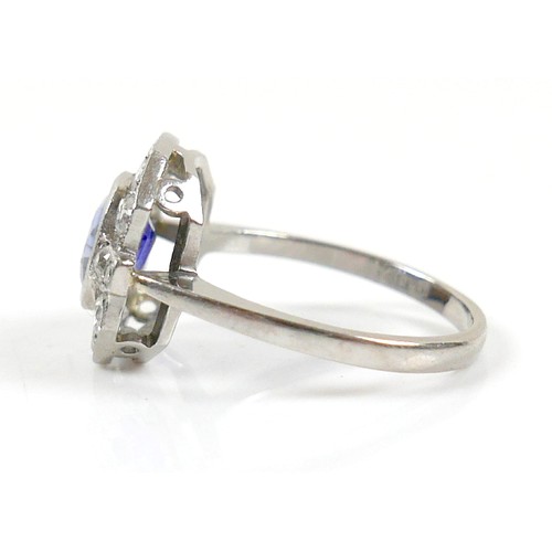 5 - An 18ct white gold, platinum, sapphire and diamond ring, the central oval cut sapphire approximately... 