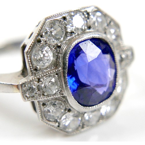 5 - An 18ct white gold, platinum, sapphire and diamond ring, the central oval cut sapphire approximately... 