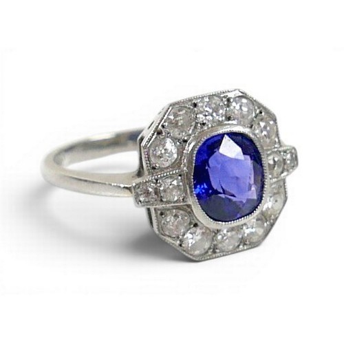 5 - An 18ct white gold, platinum, sapphire and diamond ring, the central oval cut sapphire approximately... 