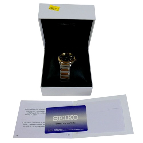99 - A  Seiko Solar stainless steel and gold plated wristwatch, 36mm case, black dial with batons and Day... 