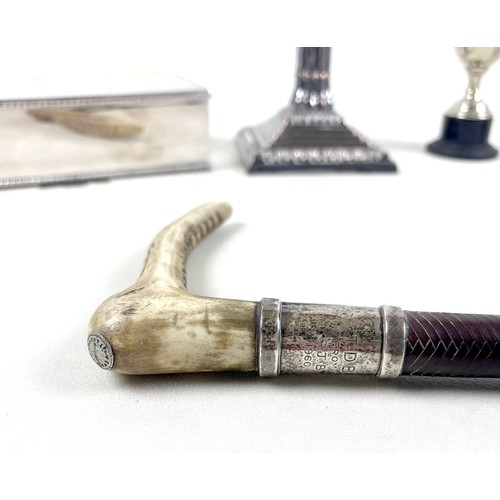 221 - A leather riding crop, with antler handle and silver collar, together with a silver plated Corinthia... 