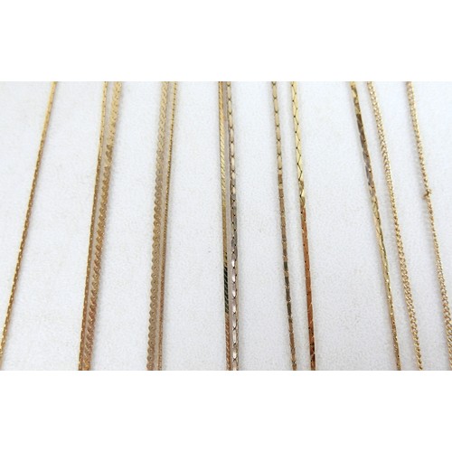 15 - A collection of gilt metal costume jewellery and numismatics, including a 1928 silver dollar pendant... 