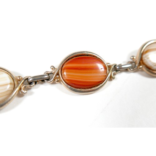 28 - Three bracelets and an opera purse, comprising a coin bracelet, and agate bracelet and a Chinese jad... 