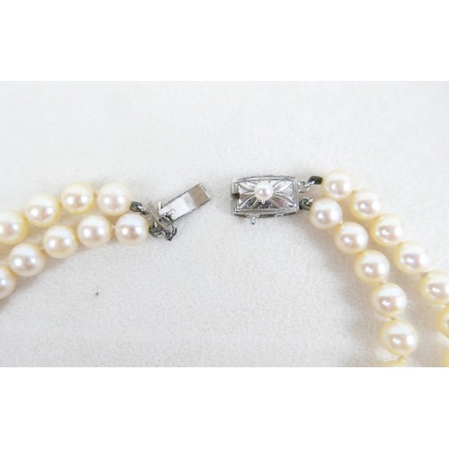 30 - A silver ingot pendant on chain, hallmarked, 40.4g, plus two pearl necklaces; single strand 14cm and... 