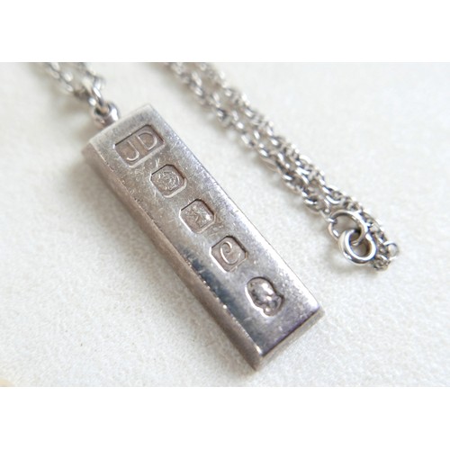 30 - A silver ingot pendant on chain, hallmarked, 40.4g, plus two pearl necklaces; single strand 14cm and... 