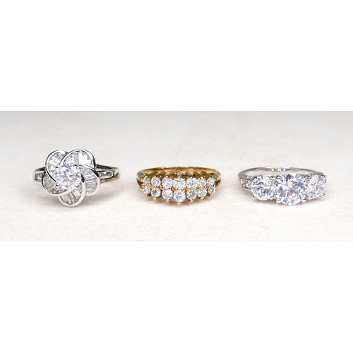 33 - Three white and gilt metal dress rings and a pair of earrings, rings size Q and R.(4)