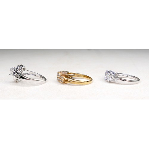 33 - Three white and gilt metal dress rings and a pair of earrings, rings size Q and R.(4)