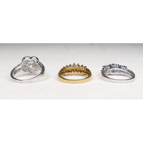 33 - Three white and gilt metal dress rings and a pair of earrings, rings size Q and R.(4)
