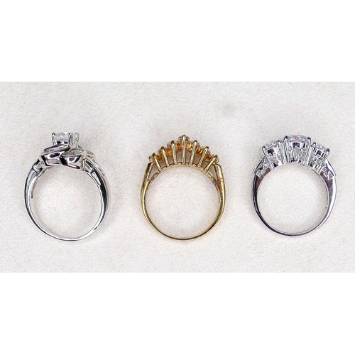 33 - Three white and gilt metal dress rings and a pair of earrings, rings size Q and R.(4)