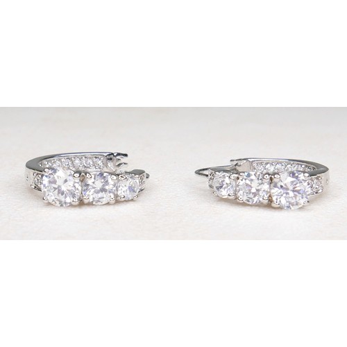 33 - Three white and gilt metal dress rings and a pair of earrings, rings size Q and R.(4)