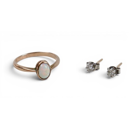 36 - A opal ring with yellow metal band, size M, 1.7g, and a pair of diamond earrings, backs stamped 375,... 