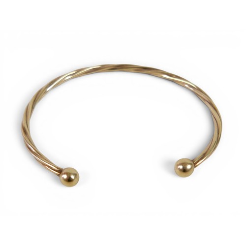 37 - A gilt metal torque style bangle 4.6g.