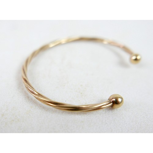 37 - A gilt metal torque style bangle 4.6g.
