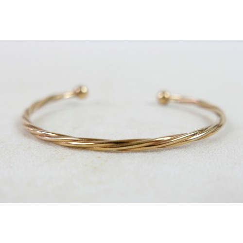 37 - A gilt metal torque style bangle 4.6g.