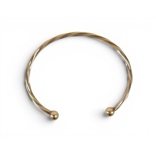 37 - A gilt metal torque style bangle 4.6g.