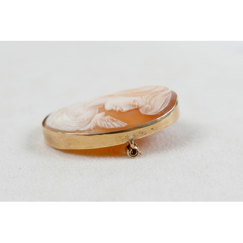 42 - A 9ct gold mounted shell carved shell cameo brooch, carved with a lady's head and bird, 3.5 by 4.5cm... 