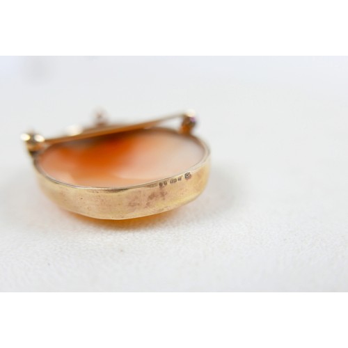 42 - A 9ct gold mounted shell carved shell cameo brooch, carved with a lady's head and bird, 3.5 by 4.5cm... 