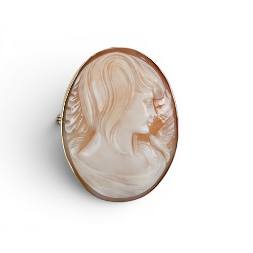 42 - A 9ct gold mounted shell carved shell cameo brooch, carved with a lady's head and bird, 3.5 by 4.5cm... 