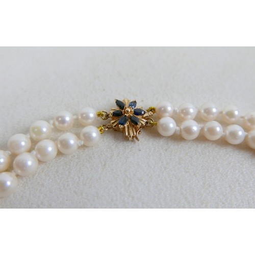 43 - A two-strand pearl necklace, with gold clasp and set with marquise sapphires, 36cm long, together wi... 