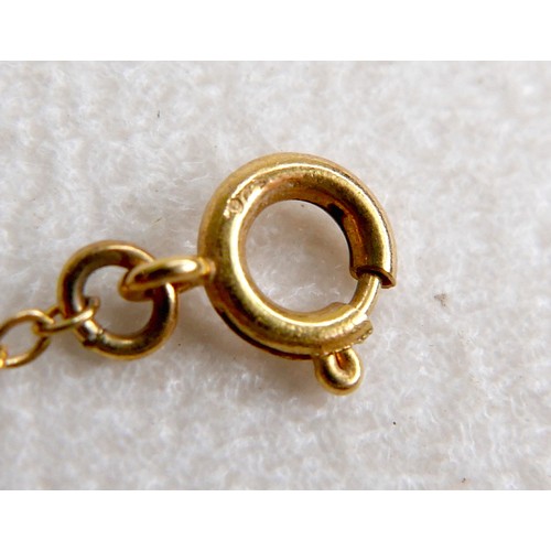 44 - A 9ct gold and smoky quartz pendant on thin gold chain, 48cm long, the central stone a large oval, t... 