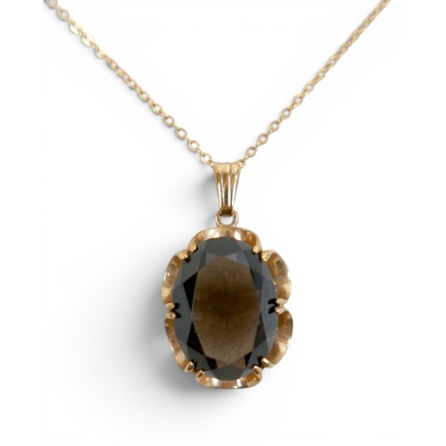 44 - A 9ct gold and smoky quartz pendant on thin gold chain, 48cm long, the central stone a large oval, t... 