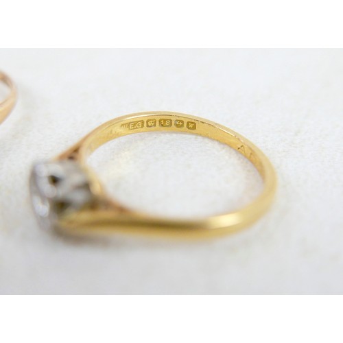 50 - Two 18ct and diamond rings; the first a solitaire diamond with leaf shoulders, size P, 2.3g, the oth... 