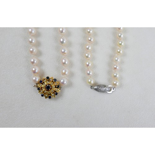 51 - Two single strand pearl necklaces, one with 9ct gold clasp set with sapphires, 72cm long, the other ... 