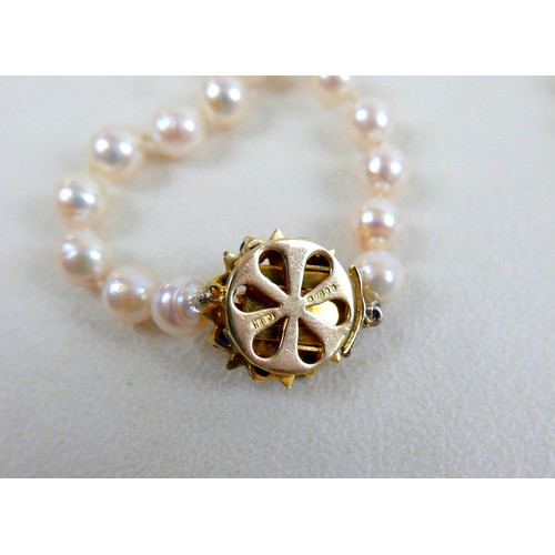 51 - Two single strand pearl necklaces, one with 9ct gold clasp set with sapphires, 72cm long, the other ... 