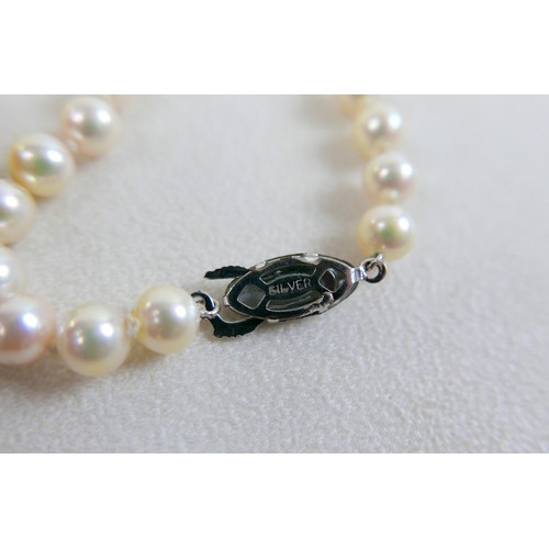 51 - Two single strand pearl necklaces, one with 9ct gold clasp set with sapphires, 72cm long, the other ... 