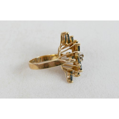 57 - A large 14k gold, sapphire and diamond dress ring, marked 585, with flowerhead of marquise cut sapph... 